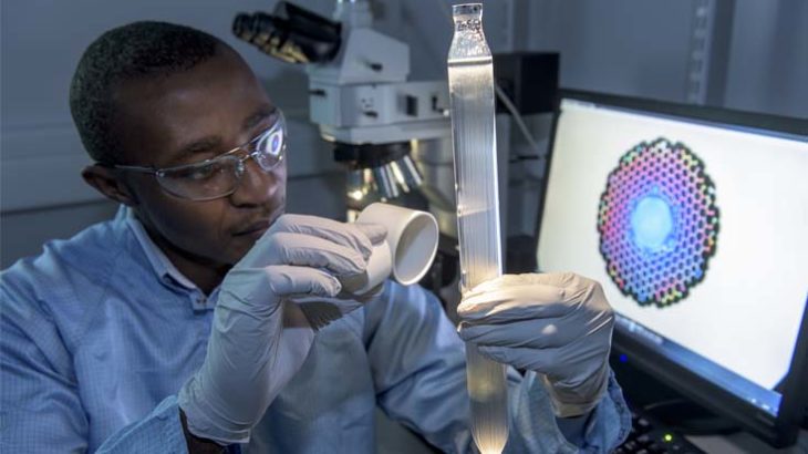 AirGuide’s Dr Eric Numkam Fokoua inspecting a Photonic Band Gap Fibre preform for imperfections