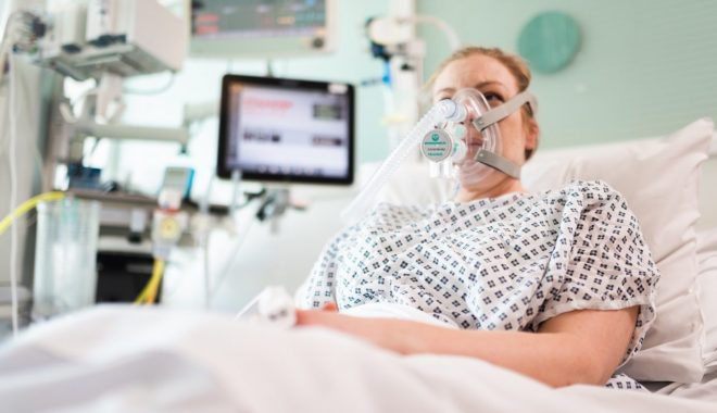 A woman pictured using the UCL / Ventura developed CPAP breathing aid (credit: James Tye / UCL)