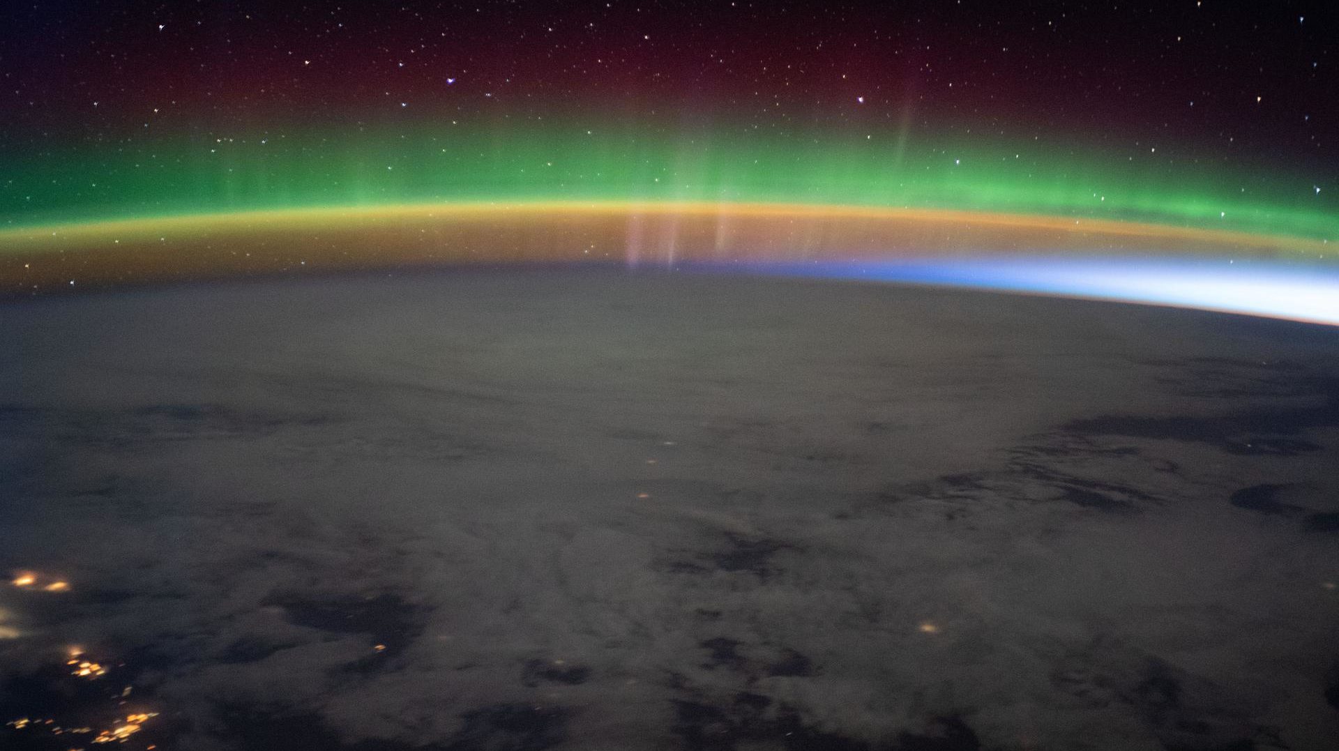 A bright aurora crowns Earth's horizon beneath a starry sky as the International Space Station flew into an orbital sunrise 264 miles above north Montana in the United States credit: NASA JSC