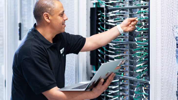 A network server specialist programmes a computer server in the Data Center at University College London. credit: Alejandro Walter Salinas Lopez