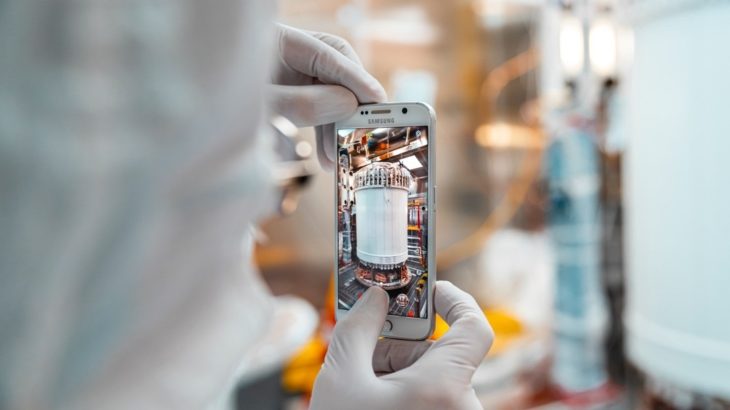 A researcher snaps a photograph of the recently assembled LUX-ZEPLIN xenon detector in the Surface Assembly Lab cleanroom at Sanford Underground Research Facility on July 26, 2019. Photo by Nick Hubbard.